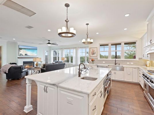 Chandelier, Dining room, Fireplace, Interior, Kitchen, Living room, Pendant Lights, Recessed Lighting, Stainless Steel Appliances, Wood Texture Flooring