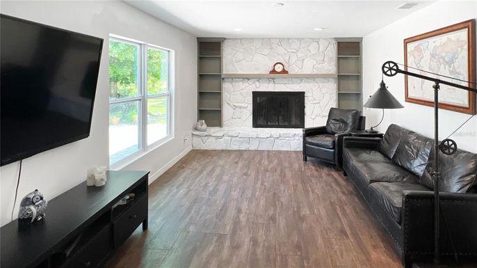 Fireplace, Interior, Living room, Recessed Lighting, Stone Walls, Wood Texture Flooring