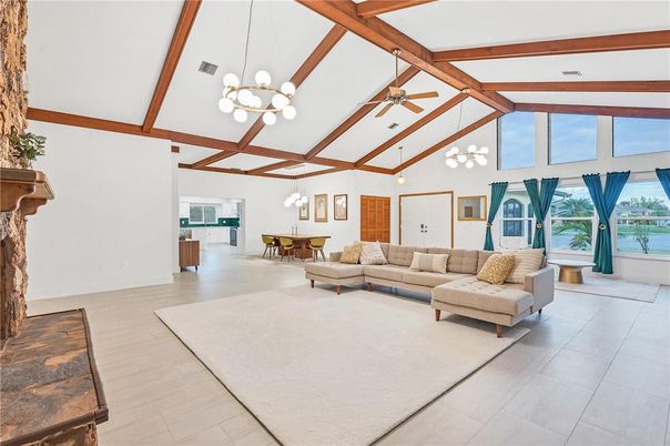 Chandelier, Dining room, Fireplace, Interior, Living room, Pendant Lights, Water, Wooden Beams