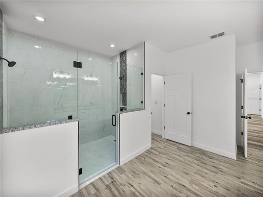 Bathroom, Glass Shower, Interior, Marble Walls, Recessed Lighting, Wood Texture Flooring