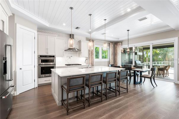 Dining room, Interior, Kitchen, Pendant Lights, Recessed Lighting, Stainless Steel Appliances, Wood Texture Flooring