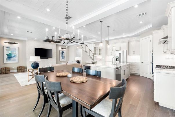 Chandelier, Dining room, Interior, Kitchen, Living room, Pendant Lights, Recessed Lighting, Stainless Steel Appliances, Wood Texture Flooring