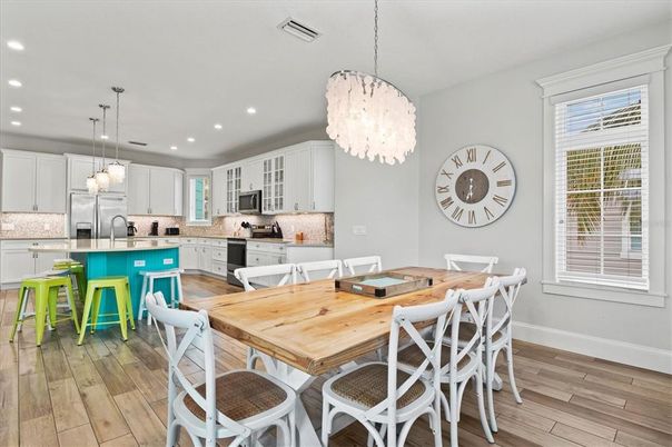 Chandelier, Dining room, Interior, Kitchen, Pendant Lights, Recessed Lighting, Stainless Steel Appliances, Wood Texture Flooring