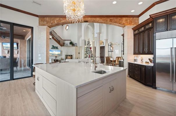Chandelier, Fireplace, Interior, Kitchen, Recessed Lighting, Stainless Steel Appliances, Wood Texture Flooring