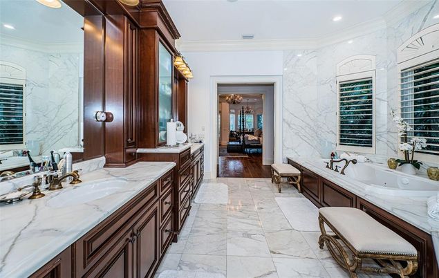 Bathroom, Dual Sink Vanities, Interior, Marble, Marble Walls, Recessed Lighting, Wood Texture Flooring