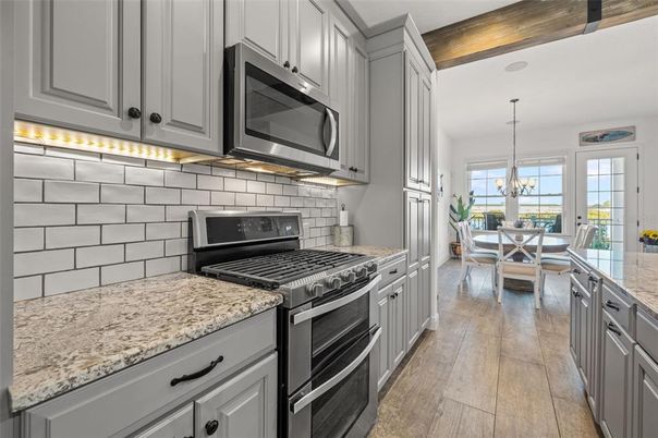 Chandelier, Dining room, Interior, Kitchen, Pendant Lights, Stainless Steel Appliances, Wood Texture Flooring