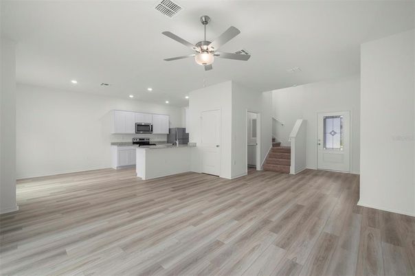 Empty room, Interior, Kitchen, Recessed Lighting, Stainless Steel Appliances, Wood Texture Flooring
