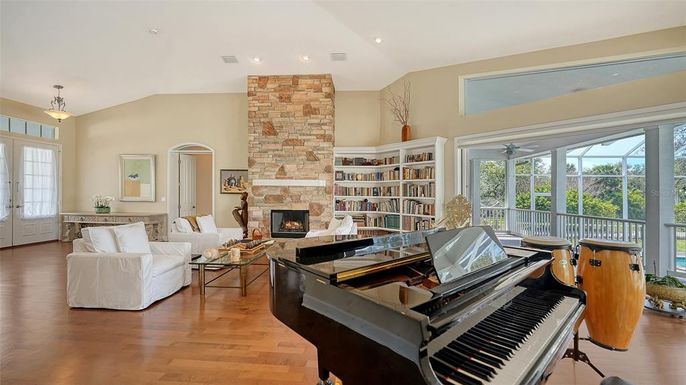 Fireplace, Interior, Living room, Piano, Recessed Lighting, Stone Walls, Wood Texture Flooring