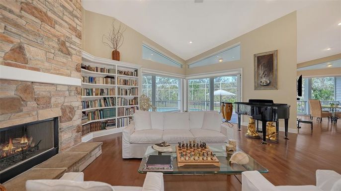 Fireplace, Interior, Living room, Piano, Recessed Lighting, Stone Walls, Wood Texture Flooring