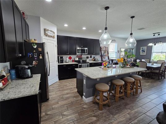 Dining room, Interior, Kitchen, Pendant Lights, Recessed Lighting, Stainless Steel Appliances, Wood Texture Flooring