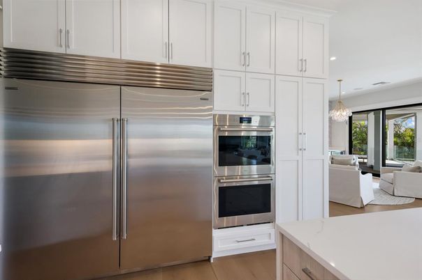 Chandelier, Dining room, Interior, Kitchen, Living room, Pendant Lights, Recessed Lighting, Stainless Steel Appliances, Wood Texture Flooring