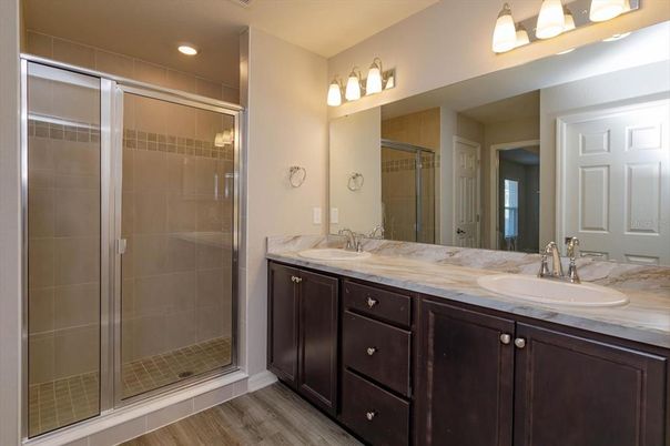 Bathroom, Dual Sink Vanities, Glass Shower, Interior, Recessed Lighting, Wood Texture Flooring