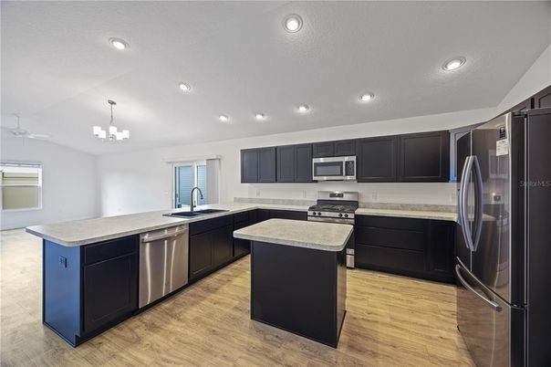 Chandelier, Interior, Kitchen, Recessed Lighting, Stainless Steel Appliances, Wood Texture Flooring