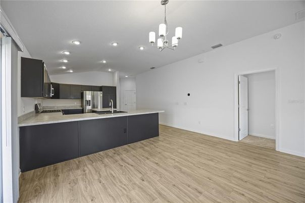Chandelier, Interior, Kitchen, Pendant Lights, Recessed Lighting, Stainless Steel Appliances, Wood Texture Flooring