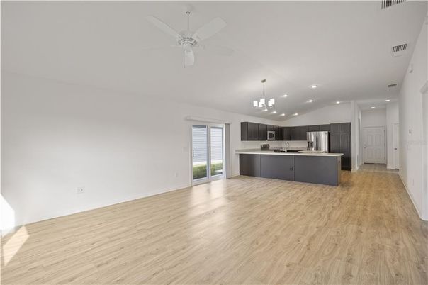 Chandelier, Empty room, Interior, Kitchen, Pendant Lights, Recessed Lighting, Stainless Steel Appliances, Wood Texture Flooring