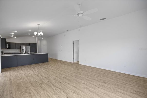 Empty room, Interior, Kitchen, Pendant Lights, Recessed Lighting, Stainless Steel Appliances, Wood Texture Flooring