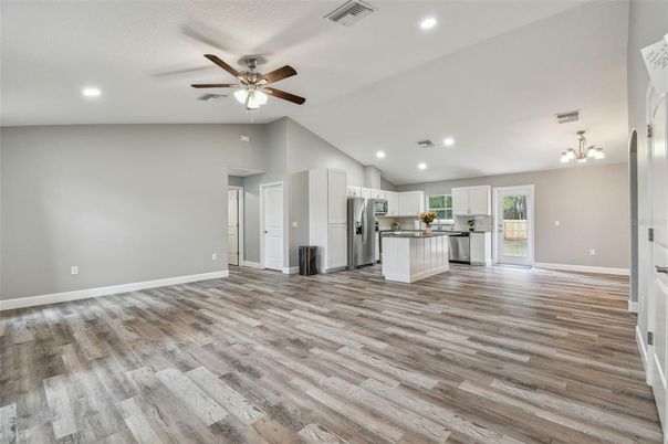 Empty room, Interior, Kitchen, Recessed Lighting, Stainless Steel Appliances, Wood Texture Flooring