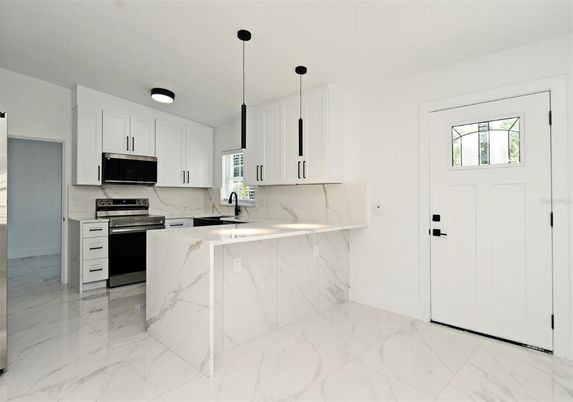 Interior, Kitchen, Marble, Marble Walls, Pendant Lights, Stainless Steel Appliances