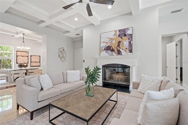 Chandelier, Dining room, Fireplace, Interior, Living room, Pendant Lights, Recessed Lighting, Wood Texture Flooring