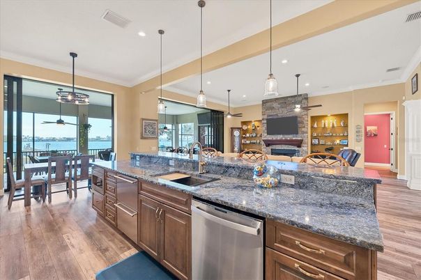 Dining room, Fireplace, Interior, Kitchen, Pendant Lights, Recessed Lighting, Stone Walls, Water, Wood Texture Flooring
