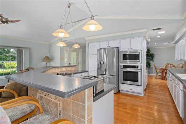 Dining room, Interior, Kitchen, Pendant Lights, Recessed Lighting, Stainless Steel Appliances, Wood Texture Flooring