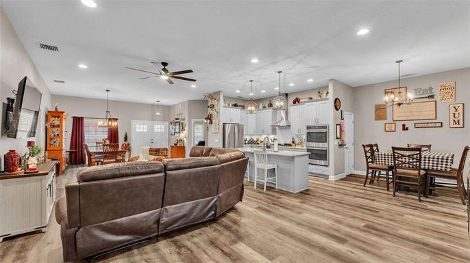 Chandelier, Dining room, Interior, Kitchen, Living room, Pendant Lights, Recessed Lighting, Stainless Steel Appliances, Wood Texture Flooring
