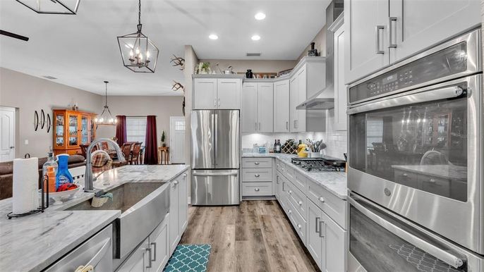 Dining room, Interior, Kitchen, Pendant Lights, Recessed Lighting, Stainless Steel Appliances, Wood Texture Flooring