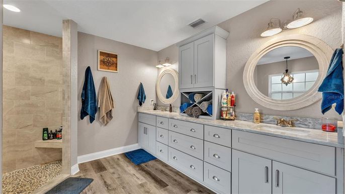 Bathroom, Dual Sink Vanities, Interior, Pendant Lights, Recessed Lighting, Stone Walls, Wood Texture Flooring