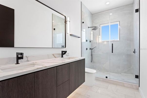 Bathroom, Dual Sink Vanities, Glass Shower, Interior, Marble Walls, Recessed Lighting