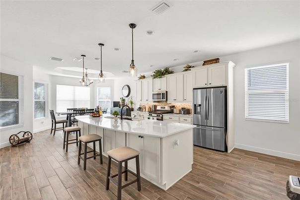 Dining room, Interior, Kitchen, Pendant Lights, Recessed Lighting, Stainless Steel Appliances, Wood Texture Flooring