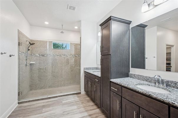 Bathroom, Dual Sink Vanities, Glass Shower, Interior, Recessed Lighting, Wood Texture Flooring
