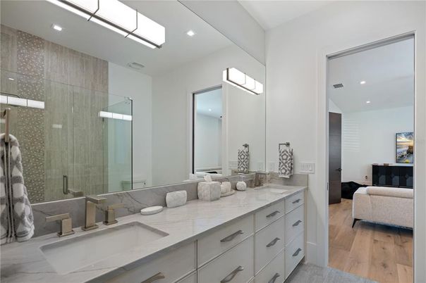 Bathroom, Dual Sink Vanities, Glass Shower, Interior, Recessed Lighting, Wood Texture Flooring