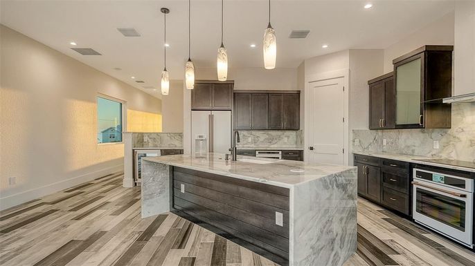 Interior, Kitchen, Marble Walls, Pendant Lights, Recessed Lighting, Stainless Steel Appliances, Wood Texture Flooring