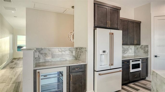 Interior, Kitchen, Marble Walls, Recessed Lighting, Stainless Steel Appliances, Wood Texture Flooring