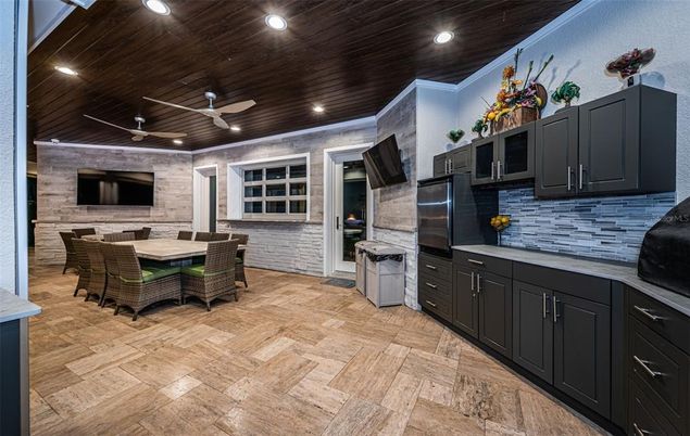 Dining room, Interior, Kitchen, Recessed Lighting, Stainless Steel Appliances, Stone Walls, Wood Texture Flooring