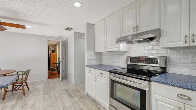 Dining room, Interior, Kitchen, Recessed Lighting, Stainless Steel Appliances, Wood Texture Flooring