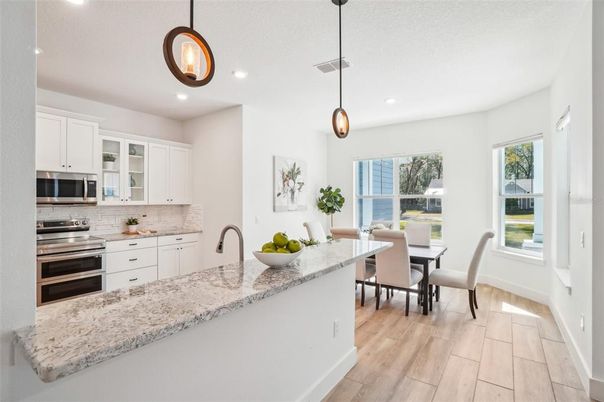 Dining room, Interior, Kitchen, Pendant Lights, Recessed Lighting, Stainless Steel Appliances, Wood Texture Flooring