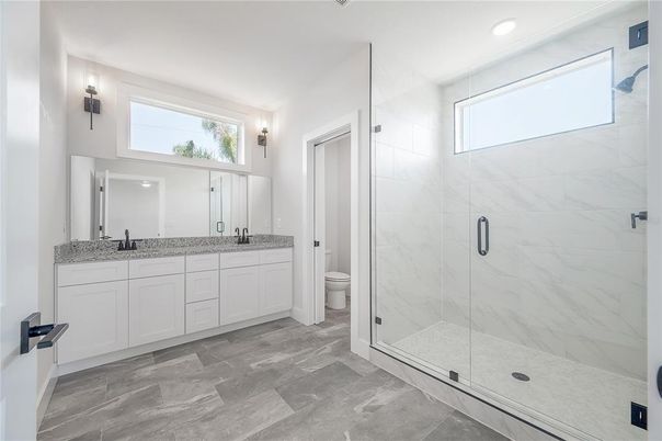 Bathroom, Dual Sink Vanities, Glass Shower, Interior, Marble Walls, Recessed Lighting