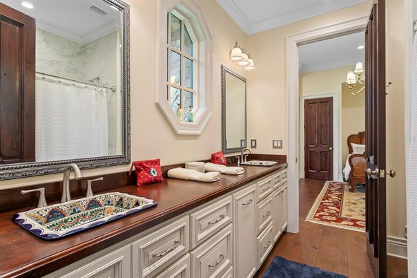 Bathroom, Dual Sink Vanities, Interior, Marble Walls, Recessed Lighting, Wood Texture Flooring