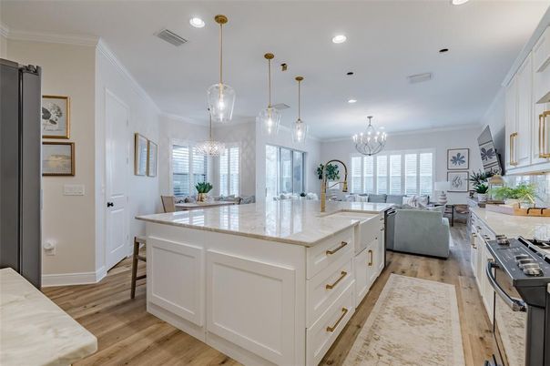 Chandelier, Dining room, Interior, Kitchen, Living room, Pendant Lights, Recessed Lighting, Stainless Steel Appliances, Wood Texture Flooring