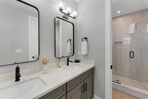 Bathroom, Dual Sink Vanities, Glass Shower, Interior, Recessed Lighting, Wood Texture Flooring