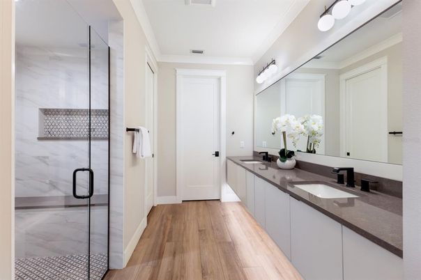 Bathroom, Dual Sink Vanities, Glass Shower, Interior, Marble Walls, Wood Texture Flooring
