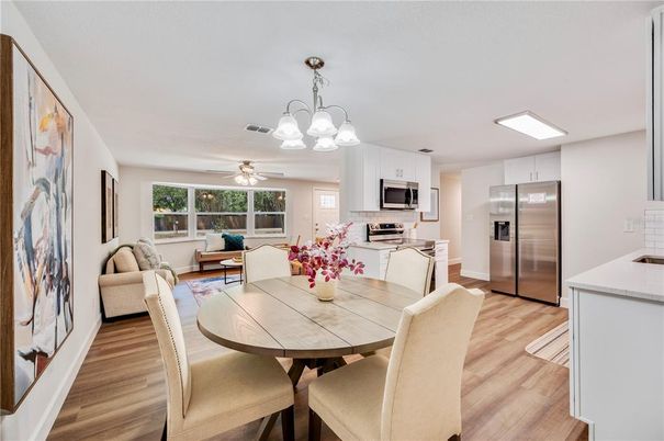 Chandelier, Dining room, Interior, Kitchen, Living room, Stainless Steel Appliances, Wood Texture Flooring