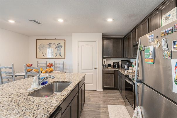 Dining room, Interior, Kitchen, Living room, Recessed Lighting, Stainless Steel Appliances, Wood Texture Flooring