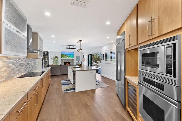 Fireplace, Interior, Kitchen, Living room, Pendant Lights, Recessed Lighting, Stainless Steel Appliances, Wood Texture Flooring