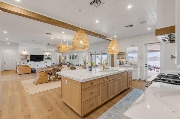 Chandelier, Dining room, Interior, Kitchen, Living room, Pendant Lights, Recessed Lighting, Stainless Steel Appliances, Wood Texture Flooring