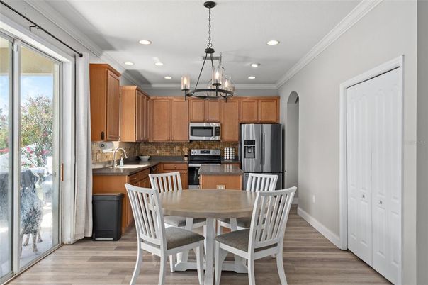 Chandelier, Dining room, Interior, Kitchen, Pendant Lights, Recessed Lighting, Stainless Steel Appliances, Wood Texture Flooring