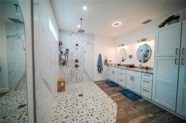 Bathroom, Dual Sink Vanities, Interior, Marble Walls, Recessed Lighting, Wood Texture Flooring