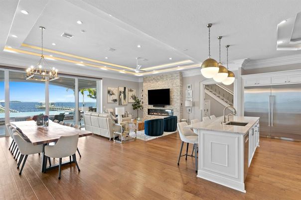 Chandelier, Dining room, Interior, Kitchen, Living room, Pendant Lights, Recessed Lighting, Stainless Steel Appliances, Water, Wood Texture Flooring