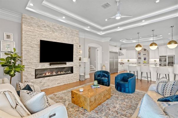 Fireplace, Interior, Kitchen, Living room, Pendant Lights, Recessed Lighting, Stainless Steel Appliances, Stone Walls, Wood Texture Flooring